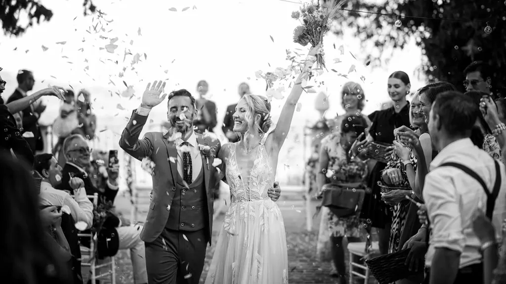 Wedding in Borgo San Faustino: a bride and groom surrounded by confetti at their wedding ceremony.